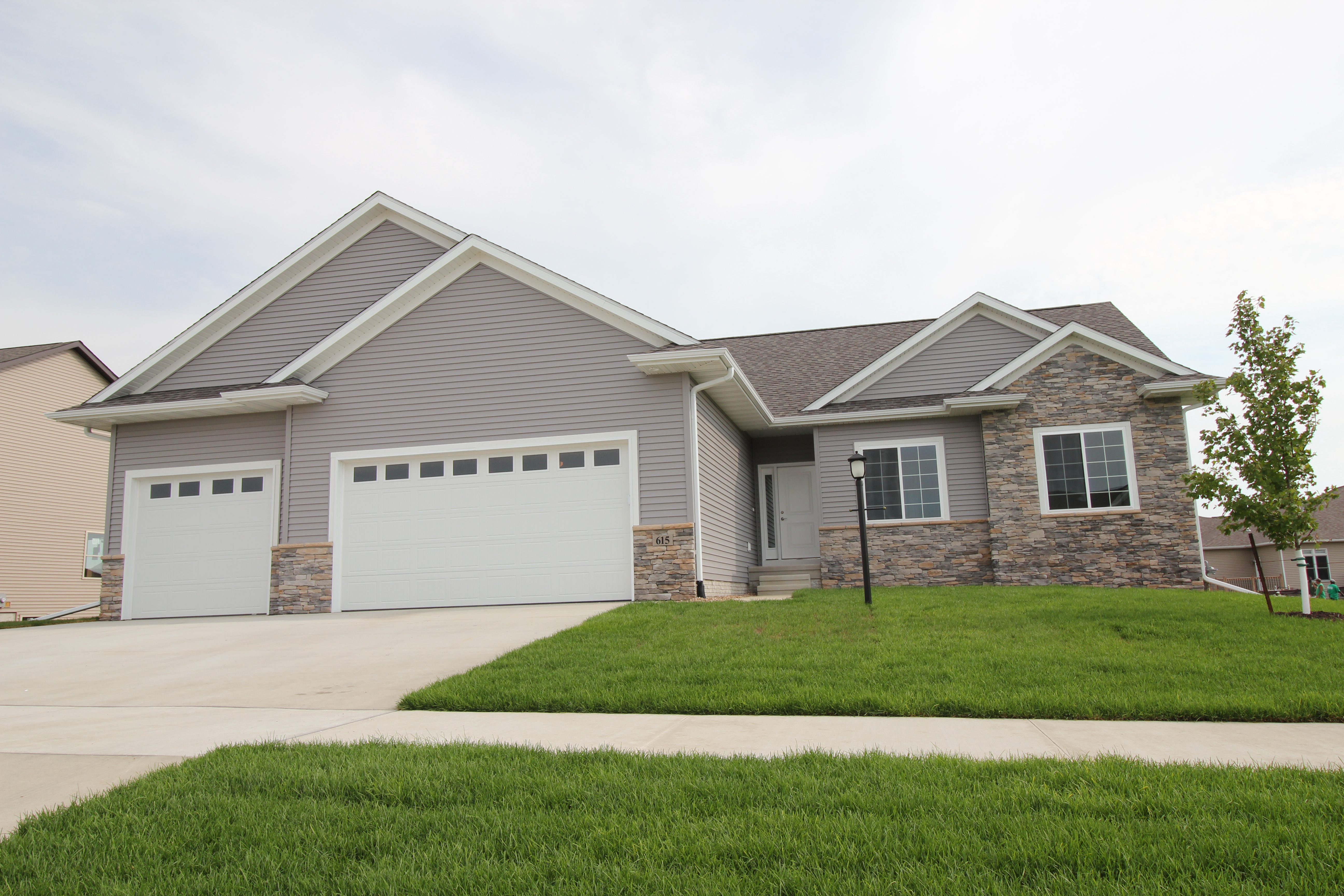 front of home with lamppost in yard