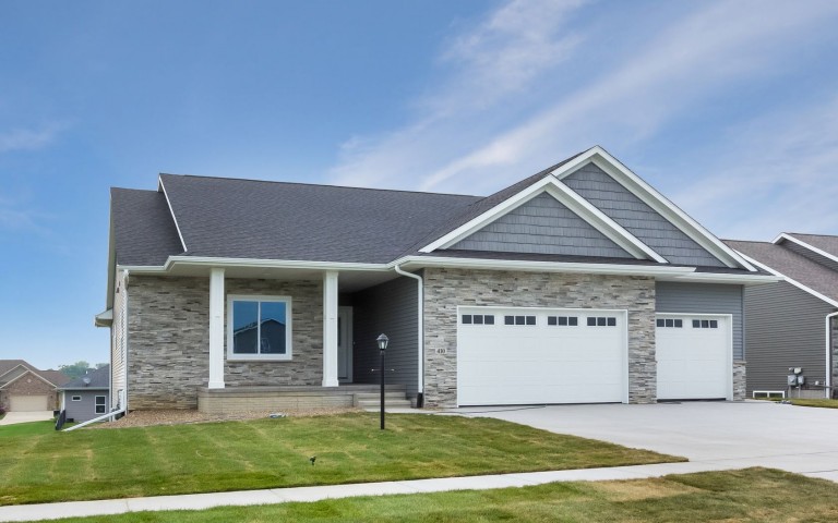 front of home with lamppost in yard