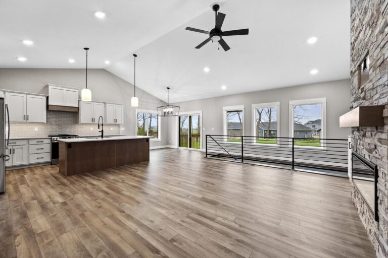 living room open to kitchen; large windows to backyard, vaulted ceiling