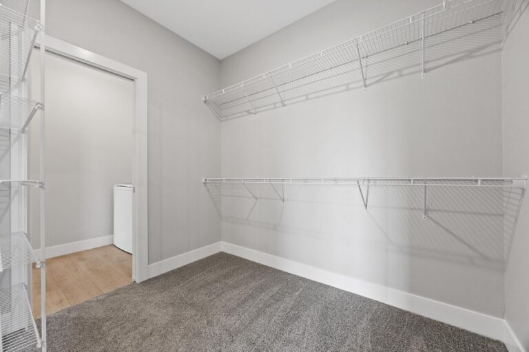 walking in closet with double hanging, wired shelving