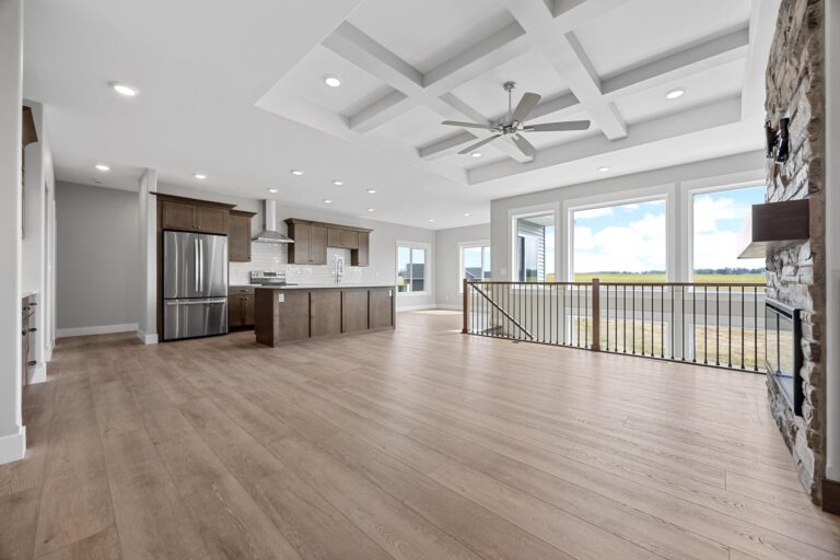 living room open to kitchen; large windows to backyard